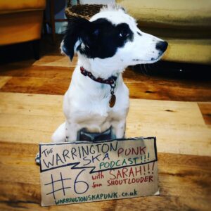 Dog with sign saying Podcast 6